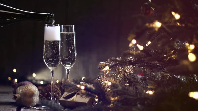 Christmas and New Year celebration. Champagne pouring into glasses. Slow motion 240 fps, 1080 full HD video
