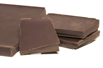 Chocolate cubes, pieces of bitter, dark chocolate bar, isolated on white background.