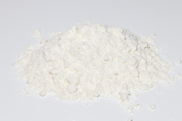 Fototapeta na wymiar Pile of wheat flour isolated on white background