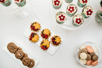 stylish luxury decorated orange candy bar for the celebration of a wedding of happy couple, cathering in the restaurant