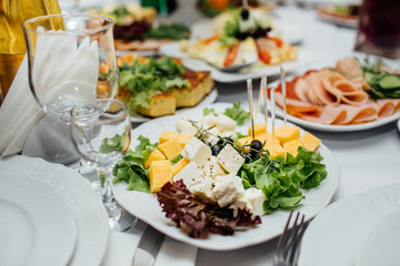 Tasty meat and vegetable snacks on the wedding table