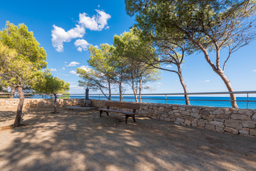 Bench on a rock in Miami Platja, Tarragona, Catalunya, Spain. Copy space for text.