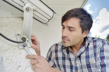 Cautious man installing a security camera