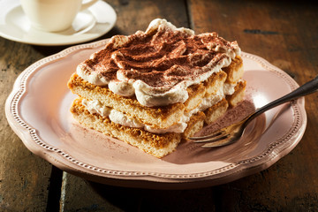 Piece of mouth-watering tiramisu cake on plate