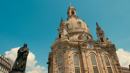Fototapeta na wymiar Frauenkirche Dresden - Baroque church with a characteristic dome on the background of the blue sky. Rebuilt from ruins after the destruction of the war.