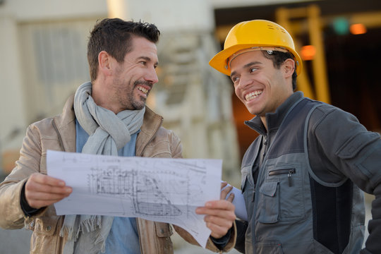 view of a worker and architect at a construction site