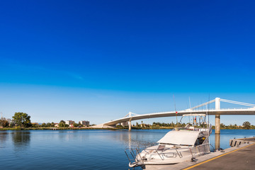 Fototapeta premium Sant Jaume d'Enveja new bridge 'Lo Passador' over Ebro river Ebro Delta, Tarragona, Catalonia, Spain. Copy space for text.