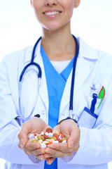 Doctor holding heap of drugs in a hand. Woman doctor