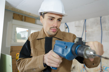 Workman using electric drill