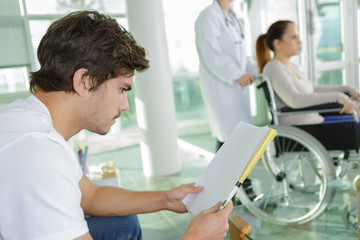 patients sitting in doctors waiting room