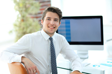 employee sitting in front of a computer screen