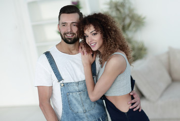 Happy young people standing in a new house