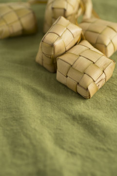 Ketupat or rice dumpling packed inside woven palm leaf pouch