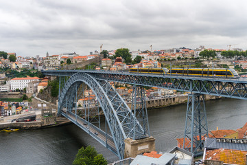 Fototapeta na wymiar Porto, Portugal - July, 2017. Panoramic aerial view of Dom Luis Bridge in Porto in a beautiful summer day, Portugal