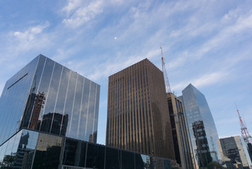 Commercial buildings with diverse architectural styles, registered in blue sky day on Avenida Paulista, São Paulo, Brazil.