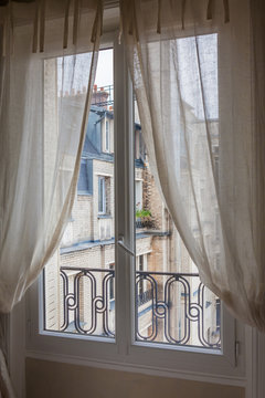Daytime view through a Paris flat window.