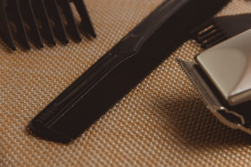 Stylish Professional Hair Clippers, accessories on brown background