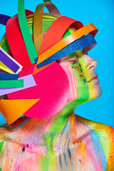 Model with colorful abstract makeup in multicolored helmet