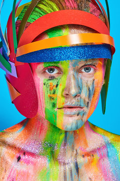 Model with colorful abstract makeup in multicolored helmet