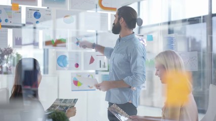  Business team in a meeting looking at photos of a power plant & discussing