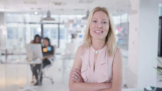  Portrait of attractive smiling businesswoman in creative office