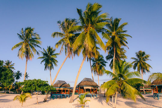 Beach huts - bungalows on a resort on beach of exotic tropical island