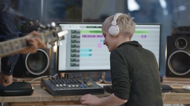  Musicians in recording studio woman listening to the music through headphones