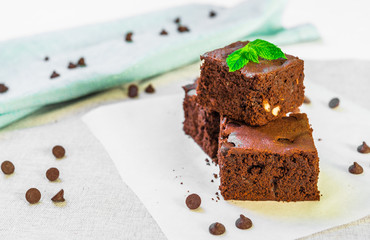 Homemade dark chocolate and cocoa brownie fudge cakes dessert with mint against white background