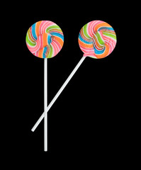 Rainbow color lollipops on black background.