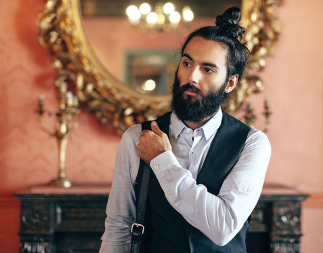 Young businessman standing on beautiful baroque room.