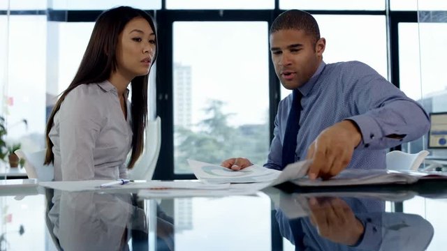  Business man & woman having an argument in office meeting
