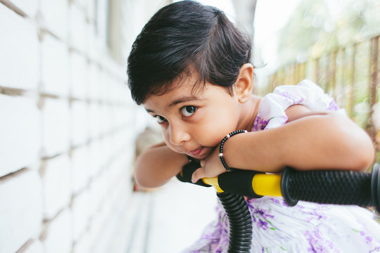 Cute toddler looking mischievously at the camera