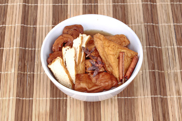 Chinese Vegetable festival  food as fried tofu and fermented flour in brown soup.