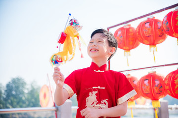 Young chinese boy playing lion puppet in chinese new year festival