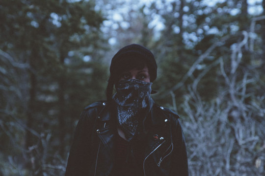 Young woman wearing mask in woods