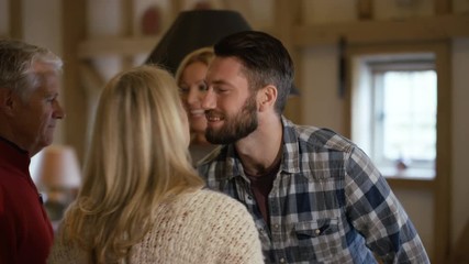 Happy family at Xmas, parents meeting daughter's boyfriend for 1st time