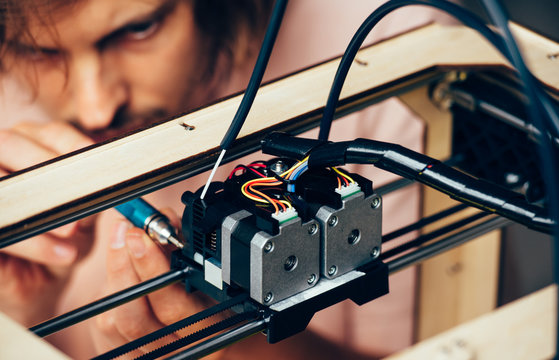 Technician working with 3d printer