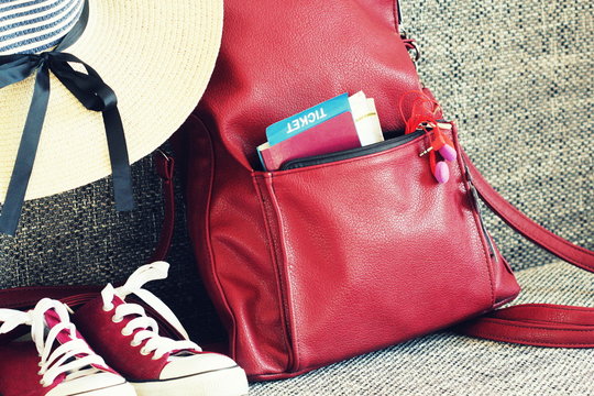 Women summer outfit: red sneakers, backpack, hat , headphones. Traveling background and tourist stuffs