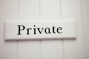 White Private Sign on White Wooden Panel Wall
