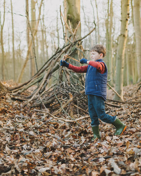 Boy playing in the woods