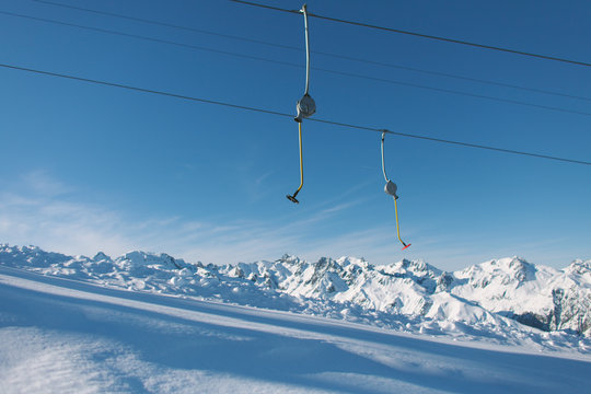 Empty tow ski rope dangling under the blue skies up in the mountains