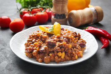 Plate with chili con carne on table
