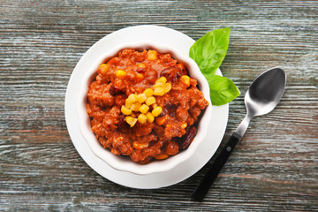 Bowl with chili con carne on table