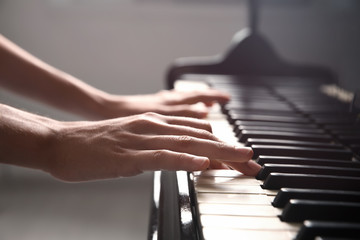 Fototapeta na wymiar Talented woman playing piano