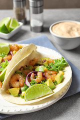 Plate with delicious shrimp tacos on table, closeup