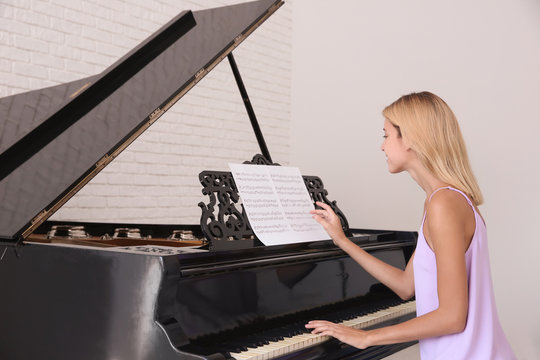 Talented woman playing piano indoors