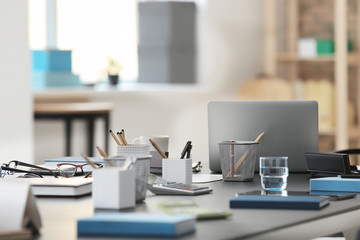Table with modern laptop and stationery in office © Africa Studio