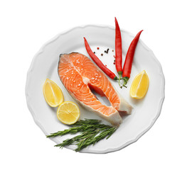 Plate with fresh salmon steak on white background