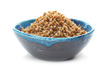 Bowl with cooked buckwheat on white background