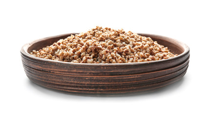 Plate with cooked buckwheat on white background